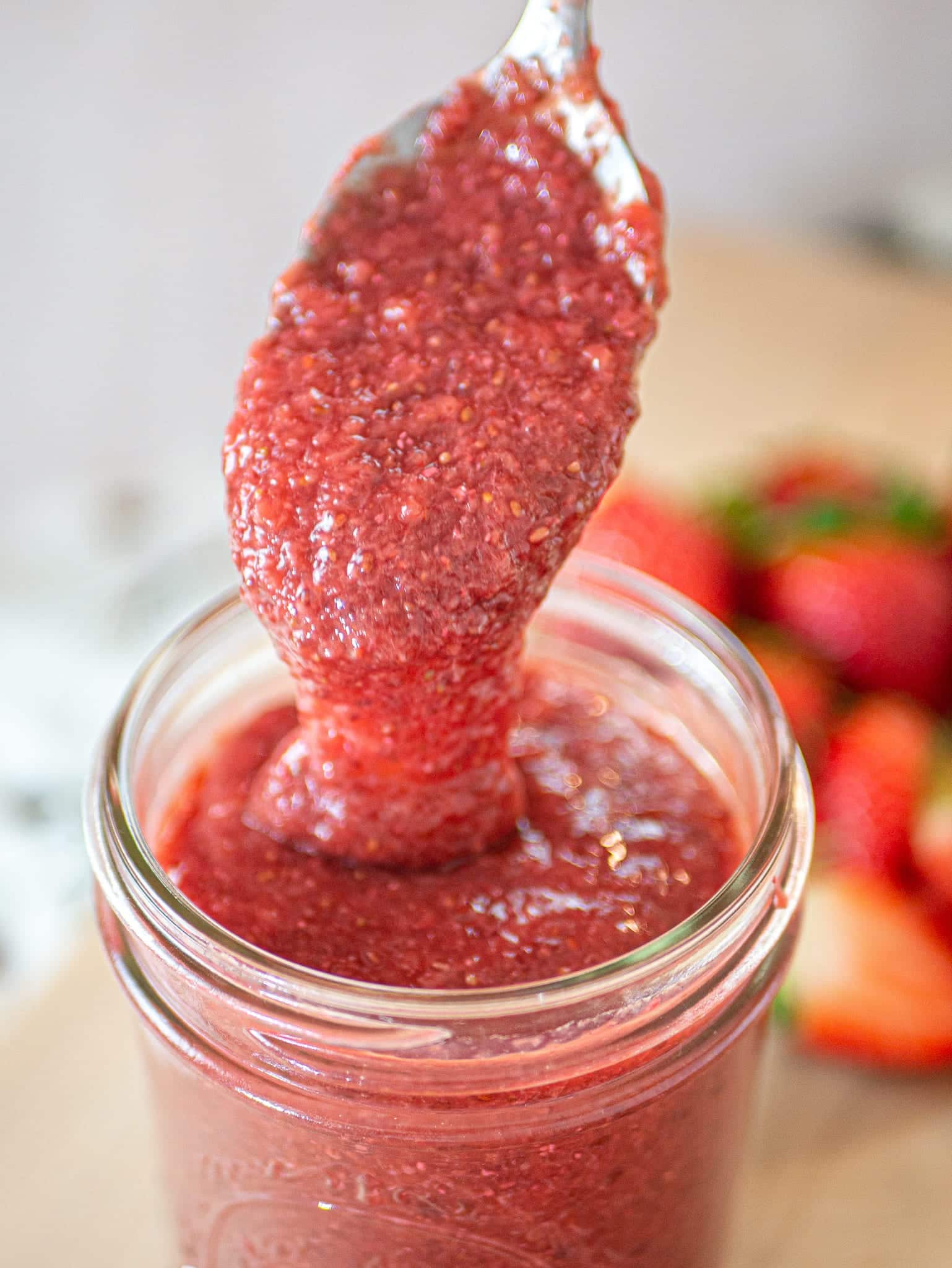 STRAWBERRY JAM DRIPPING FROM GOLDEN SPOON
