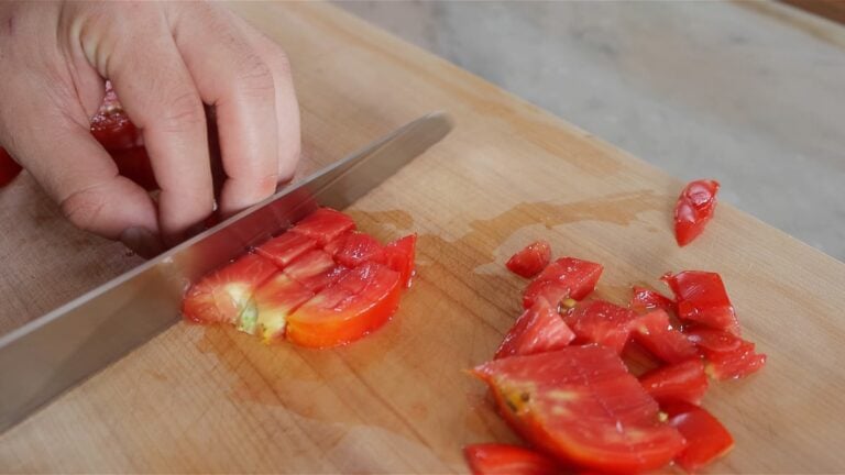 chopping the tomatoes with a serrated knife