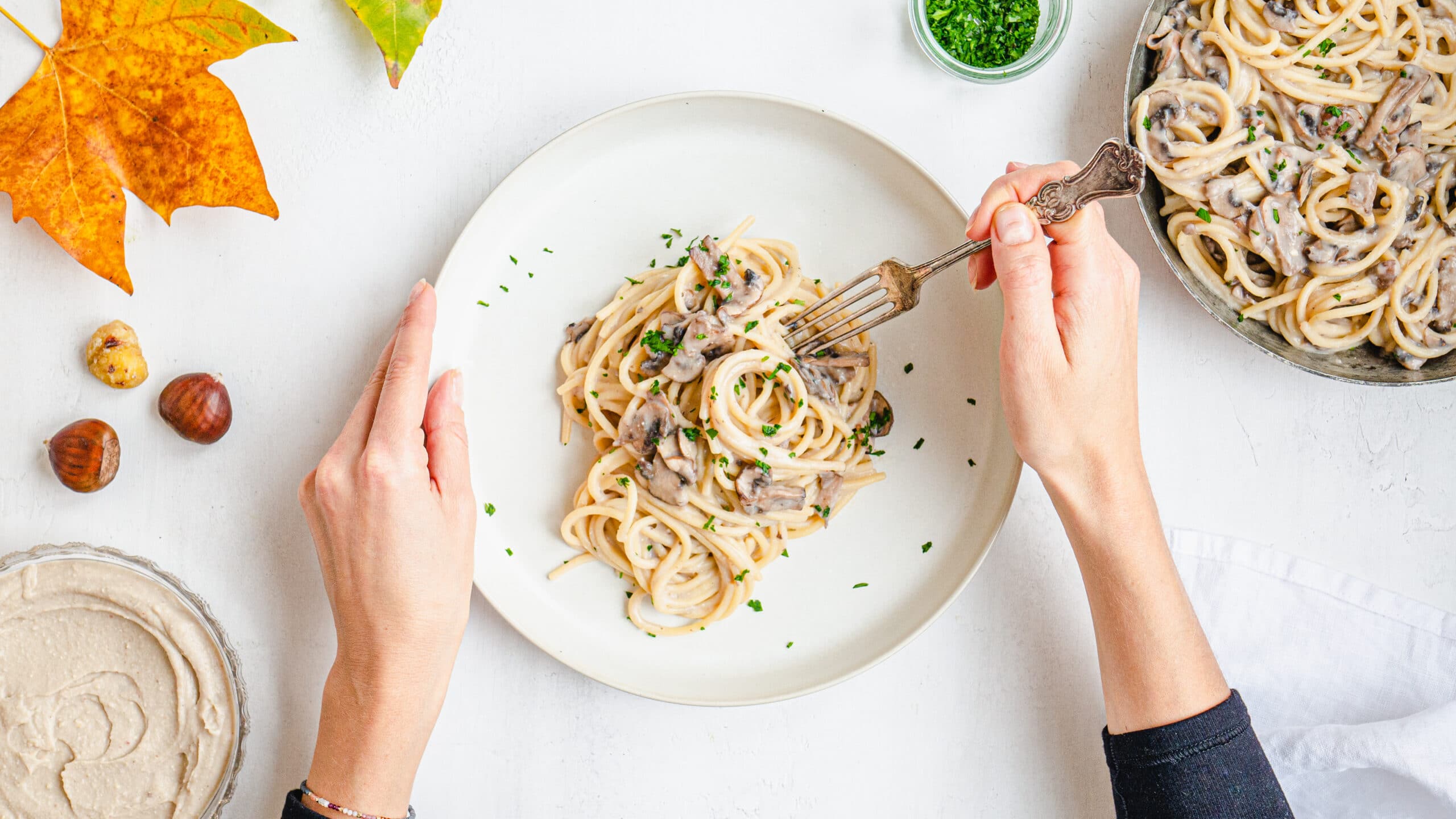 Pasta with chestnut pesto eaten by a woman