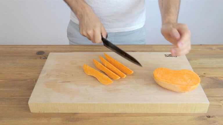 Cutting the sweet potato into wedges