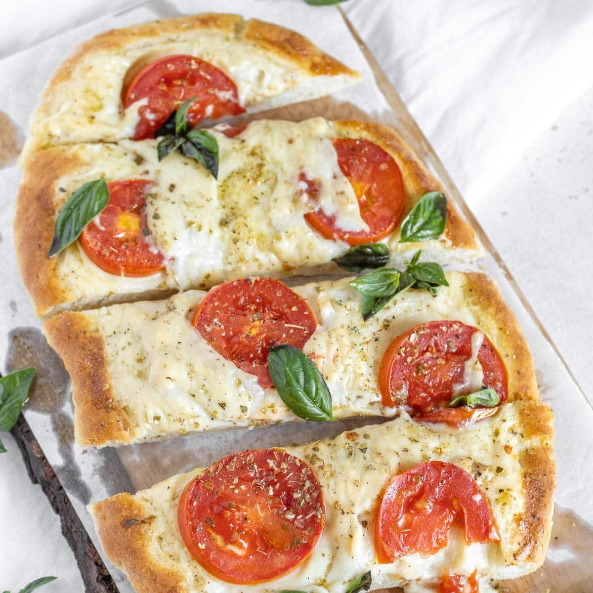 flatbread pizza with melted cheese and tomatoes