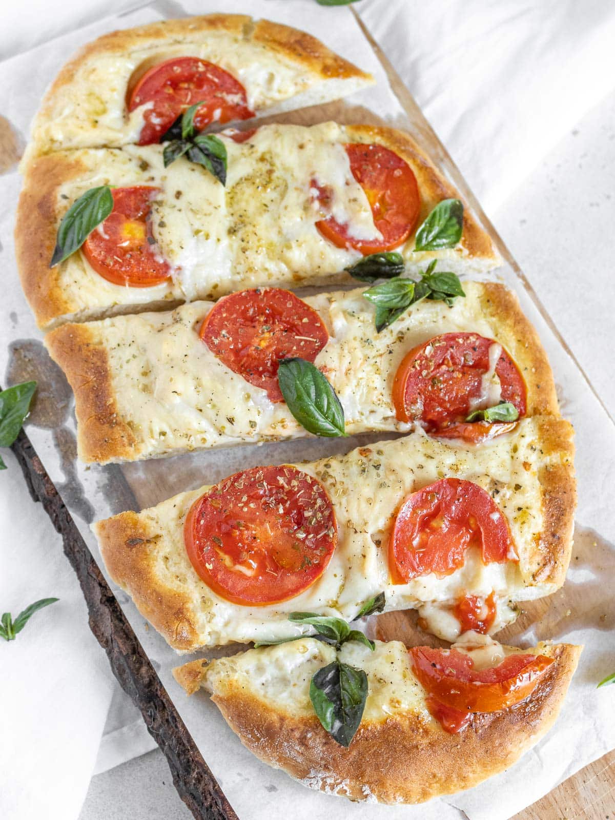 flatbread pizza with melted cheese and tomatoes