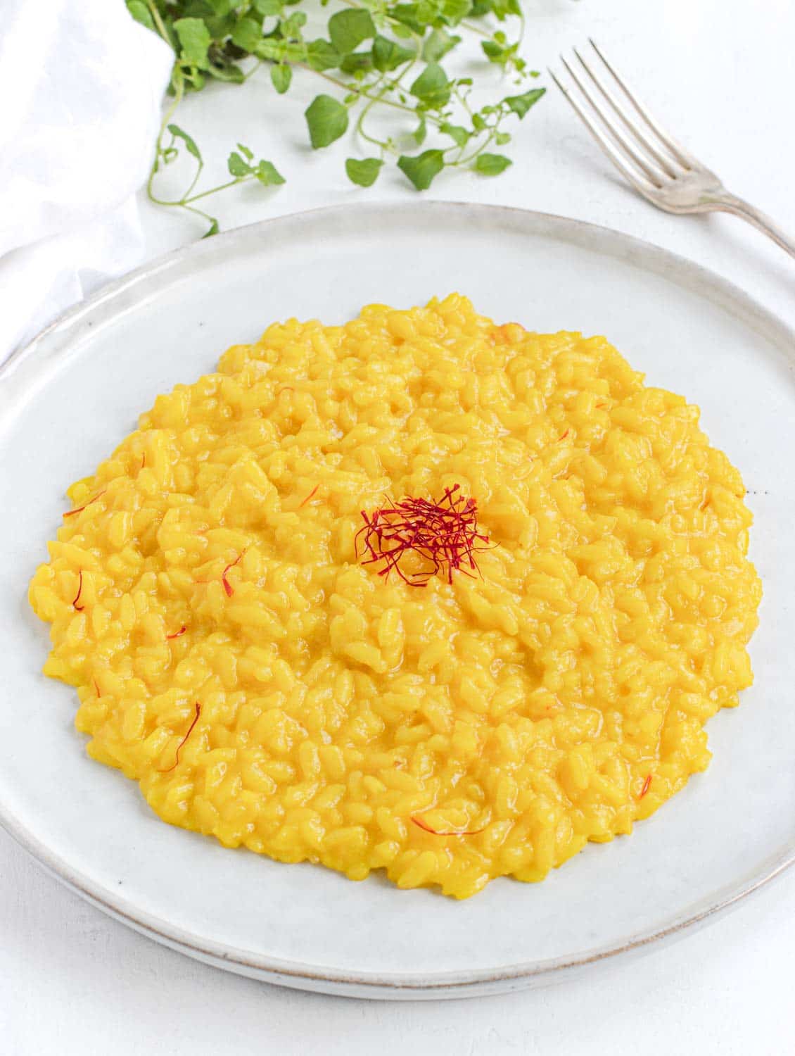 Creamy saffron risotto on a plate ready to be eaten