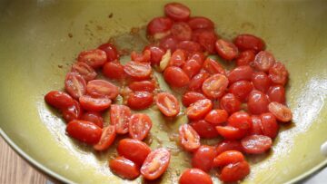 plum tomatoes frying in a pan