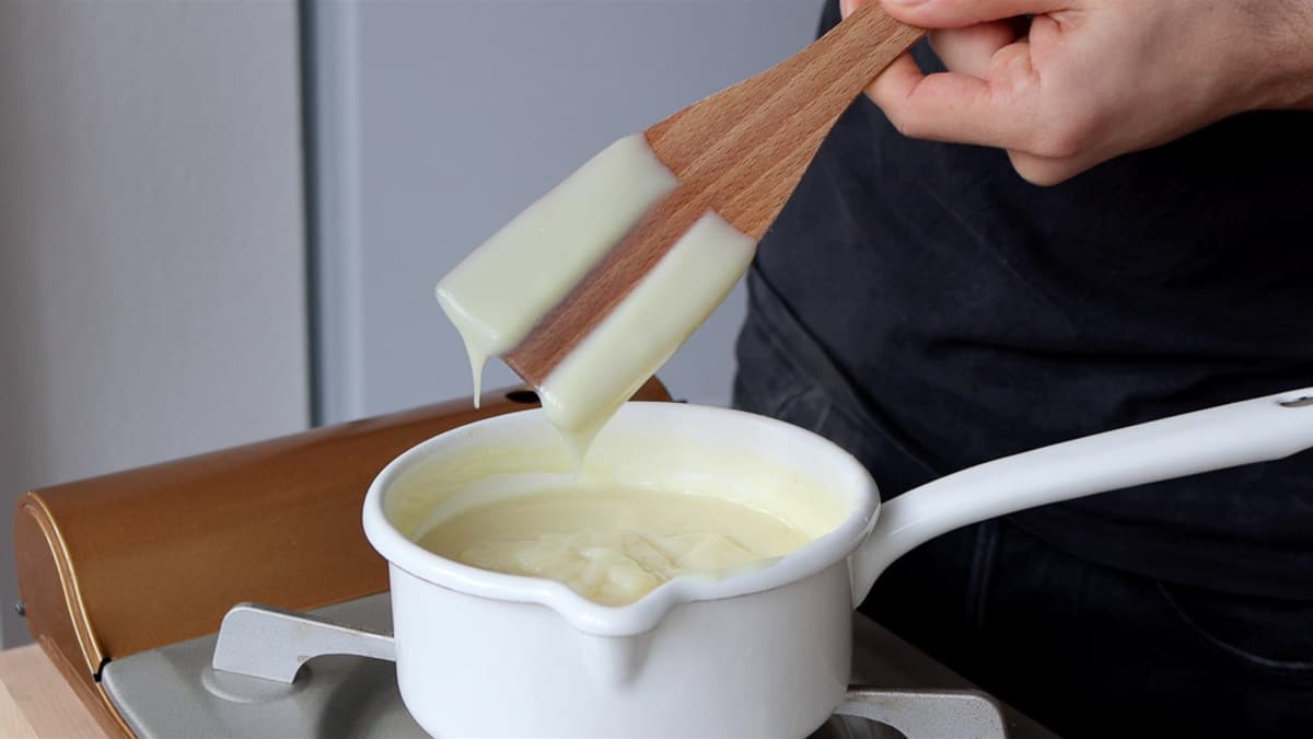 testing the thickness of the custard with a finger