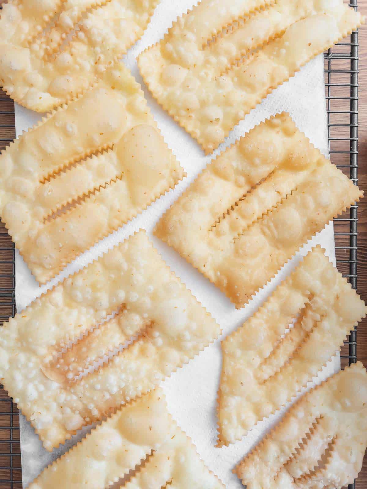 deep-fried chiacchiere on a cooling rack