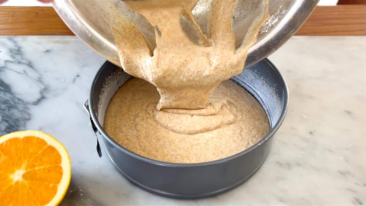 transferring the cake batter into a springform pan