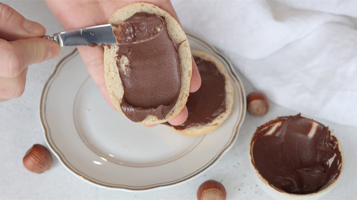 Spreading the nutella on toasted bread