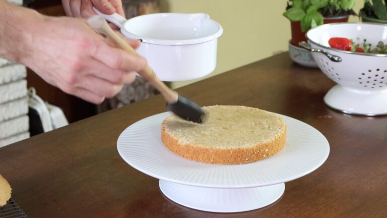 brushing the sponge cake with syrup