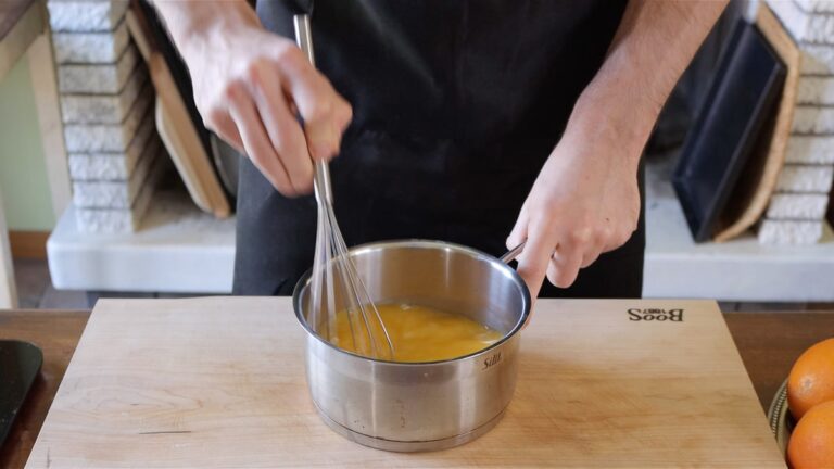 Whisking the ingredient for the eggless orange curd