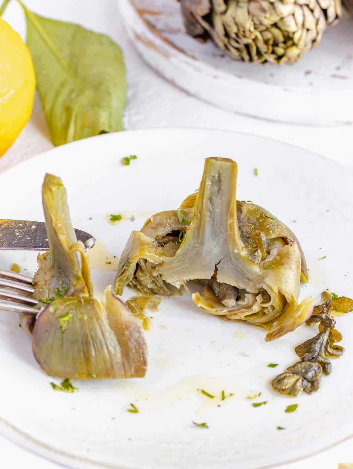 cooked artichoke on a plate
