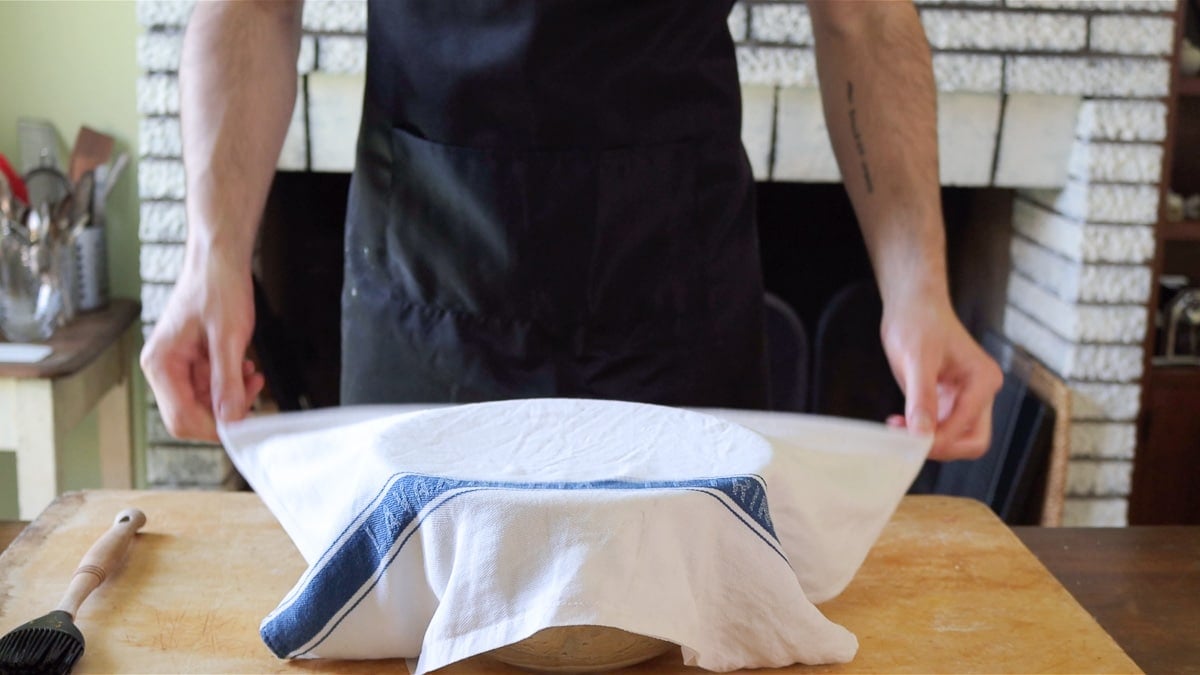 covering the dough with a damp cloth