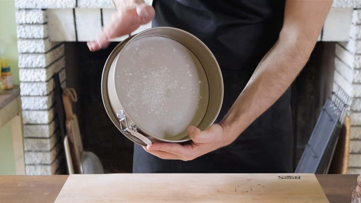 dusting the springform pan with flour