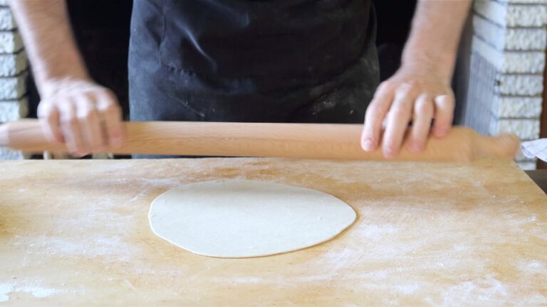 rolling the dough into a vegan piadina