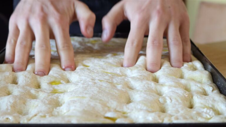 poking the focaccia with fingertips