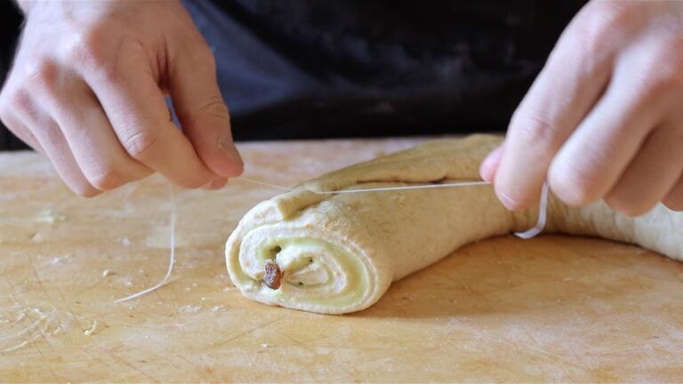 cutting the dough into small brioche rolls with custard
