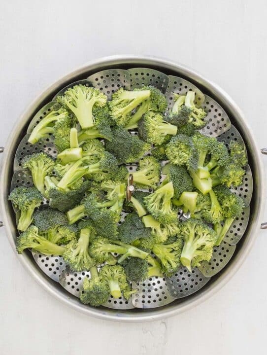 raw broccoli on a steamer