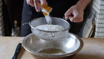 sifting flour and baking powder into a bowl