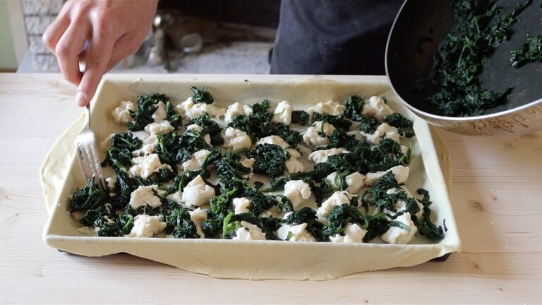adding spinach on top of the cheese