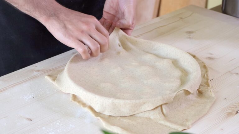 adding a sheet of rolled dough on top