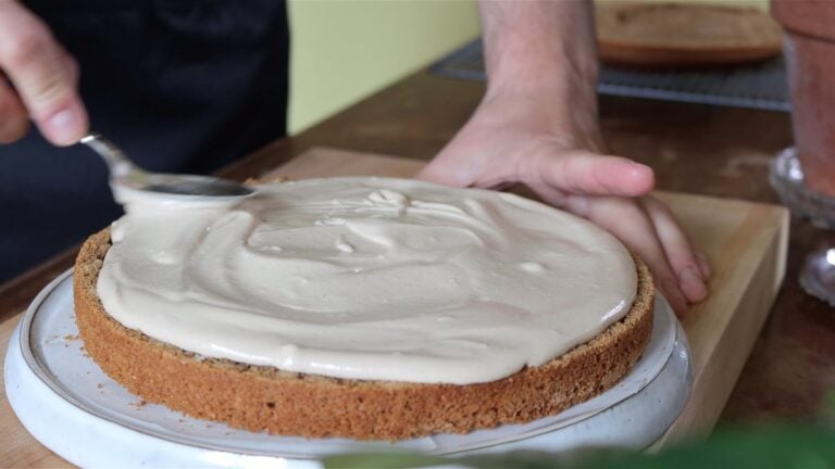 adding a layer of hazelnut cream into the cake