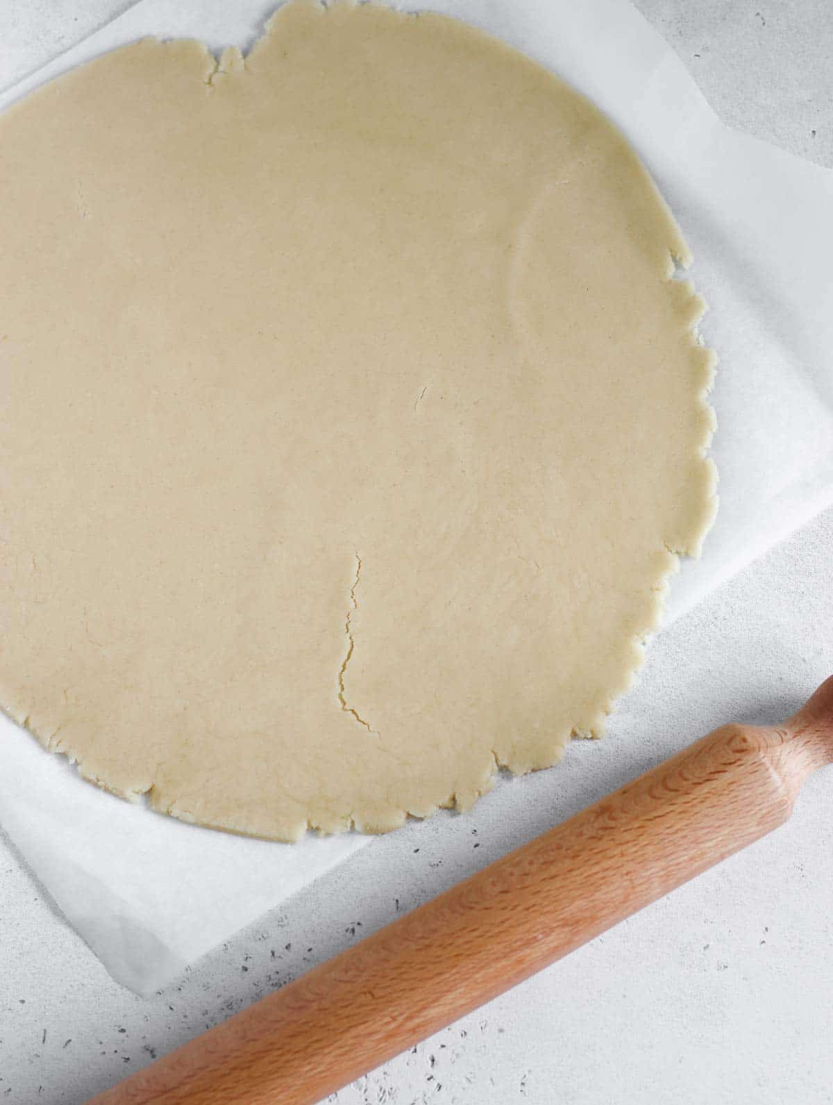 rolling the pie crust with a rolling pin