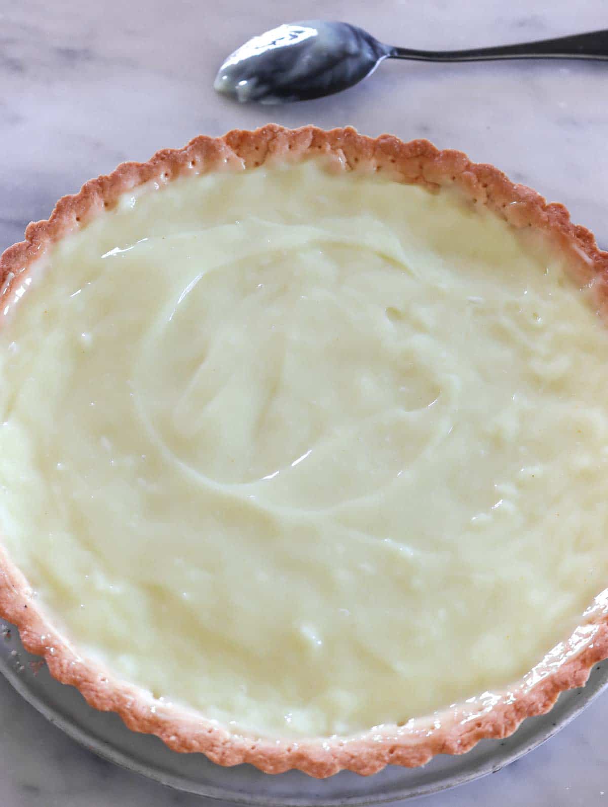 filling the pie crust with the custard