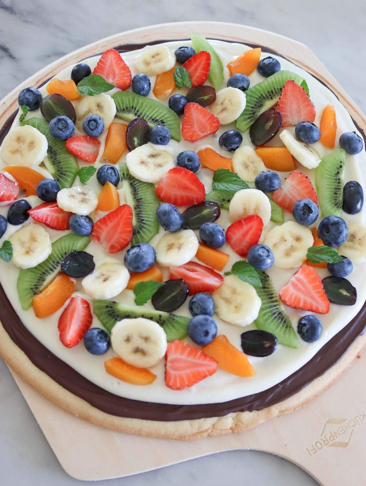 fruit pizza on a marble table 