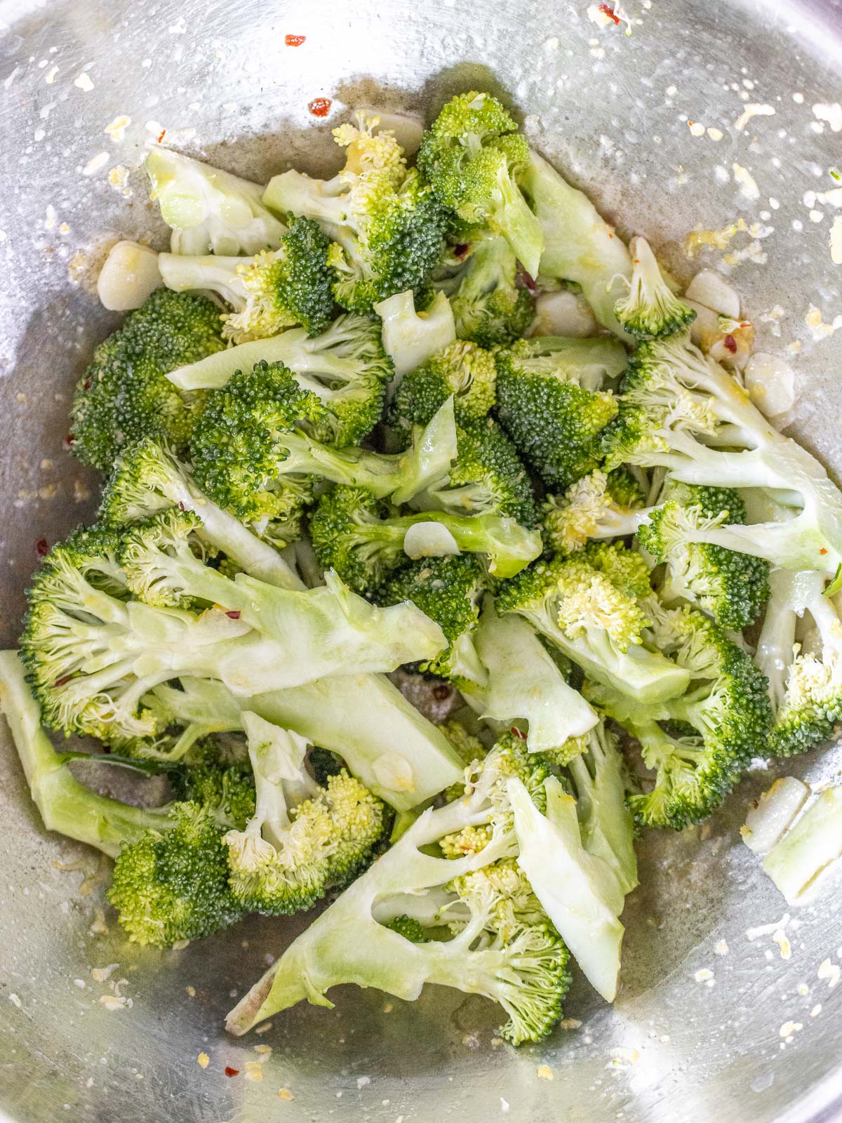 mixing the broccoli with the dressing