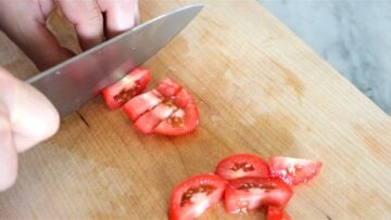cutting the roma tomatoes