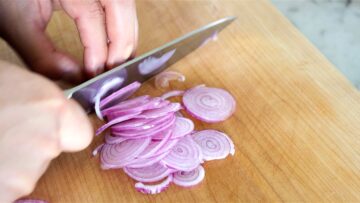 slicing the onion thinly