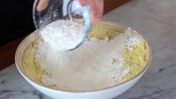adding the flour to the mashed potatoes