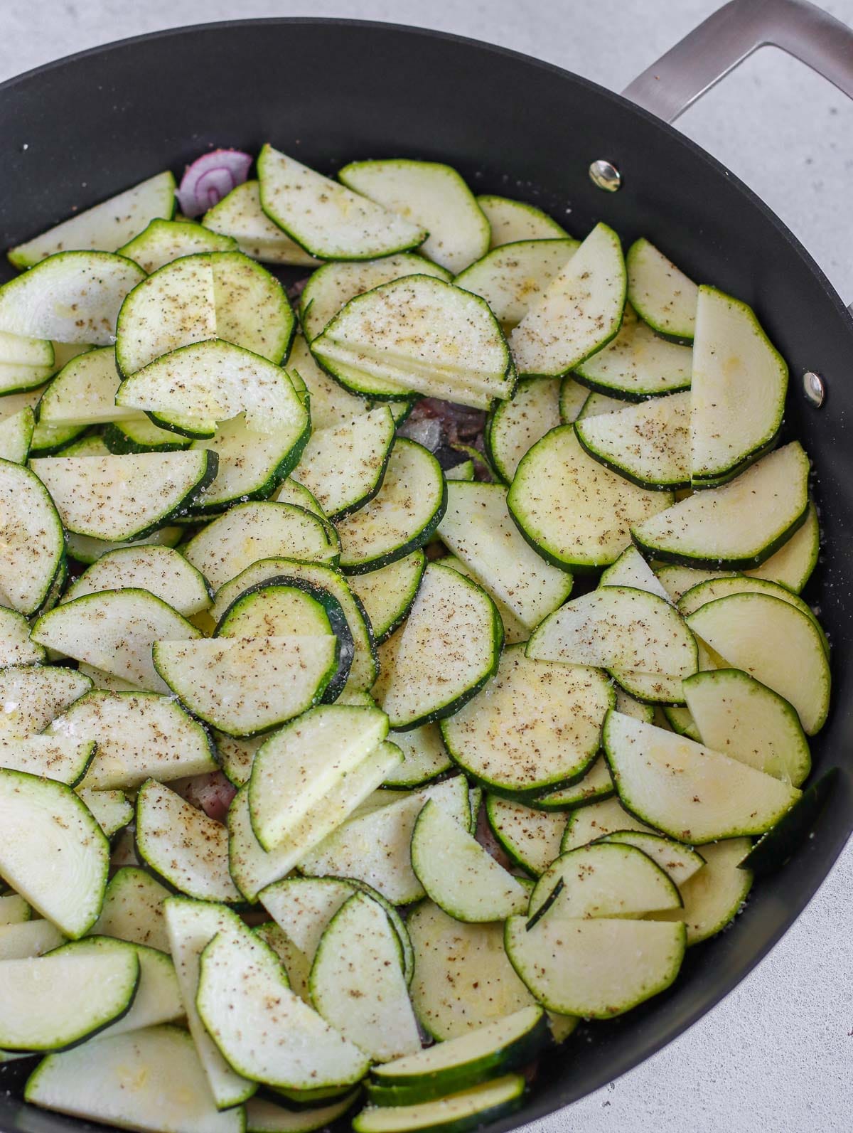 frying the zucchini with the onions