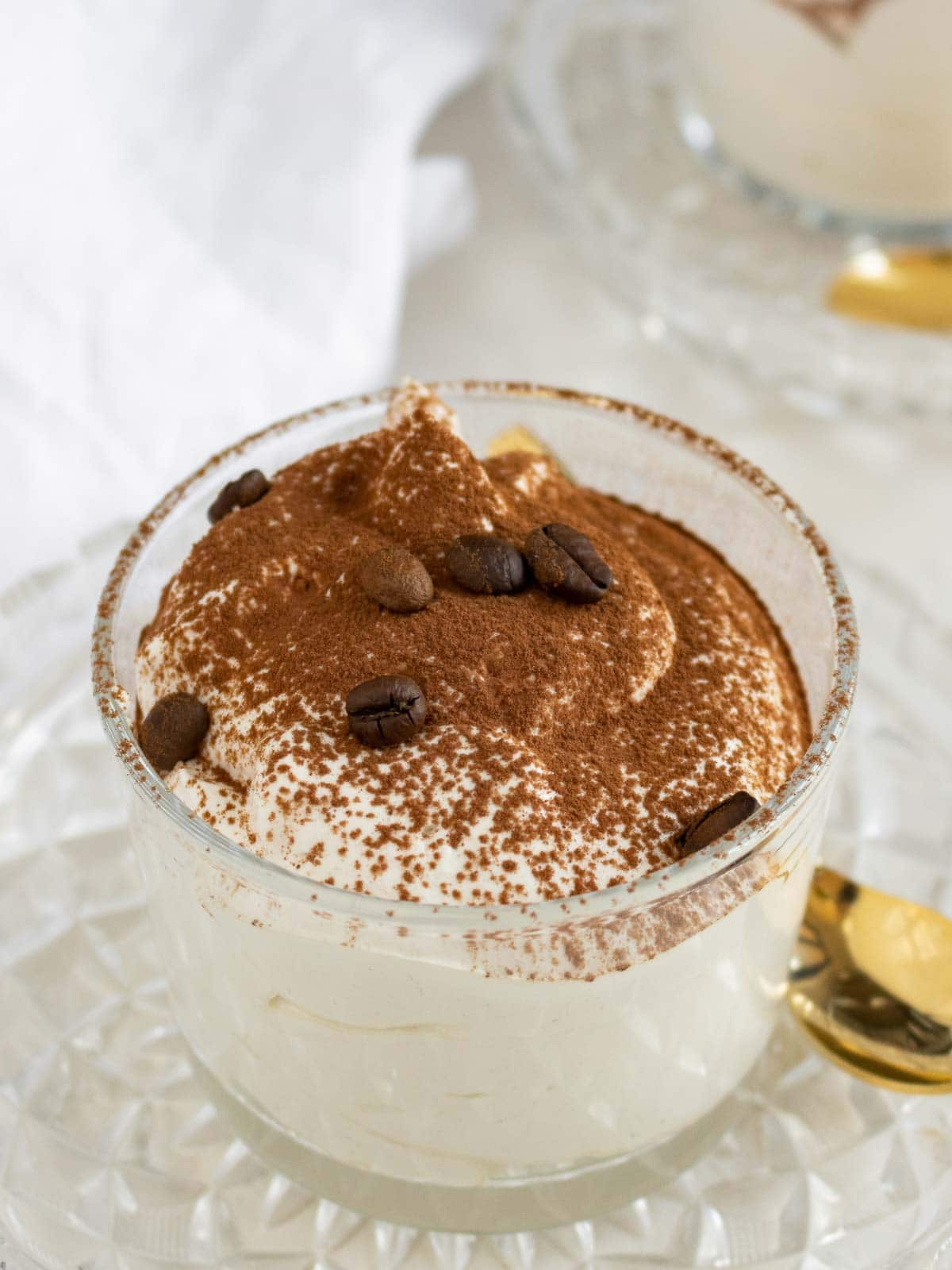 coffe mousse in a glass with cacao powder on top