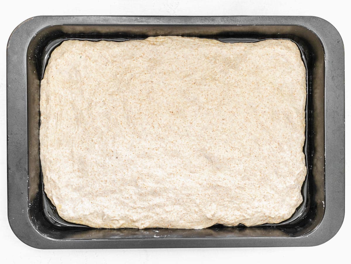 focaccia dough in a baking pan