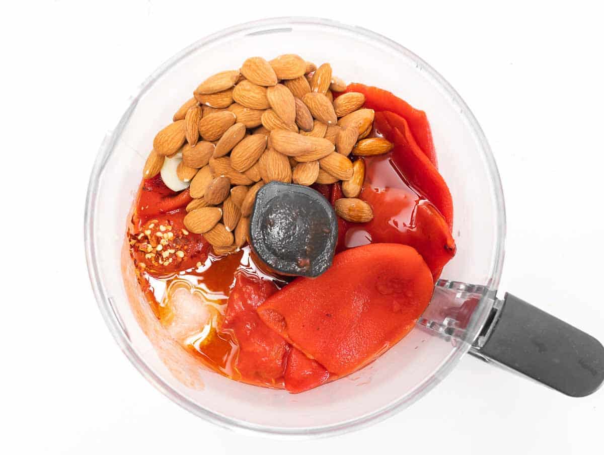 ingredients for the red pepper sauce in a food processor