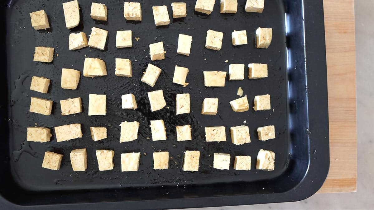 arranging the tofu cubes on a baking tray