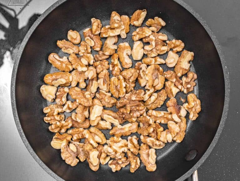 toasting walnuts in a pan