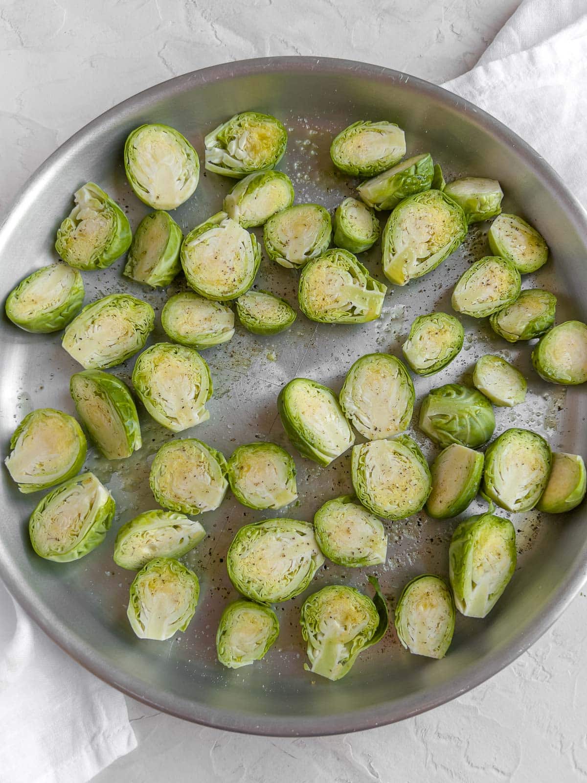 Brussels sprouts cut in half on a baking tray