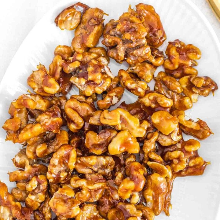 candied walnuts on a white plate