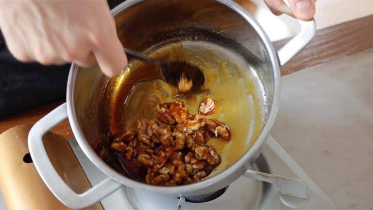coating the walnuts in the sugar