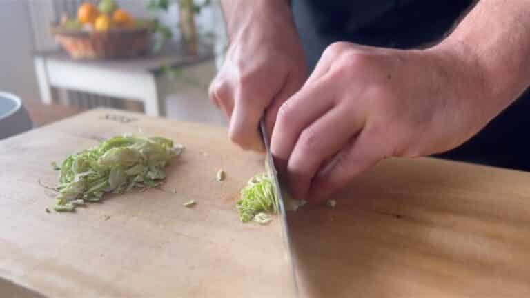 slicing the sprouts thinly with a knife
