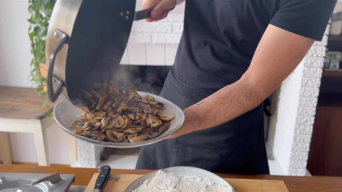 transferring the cooked mushrooms onto a plate