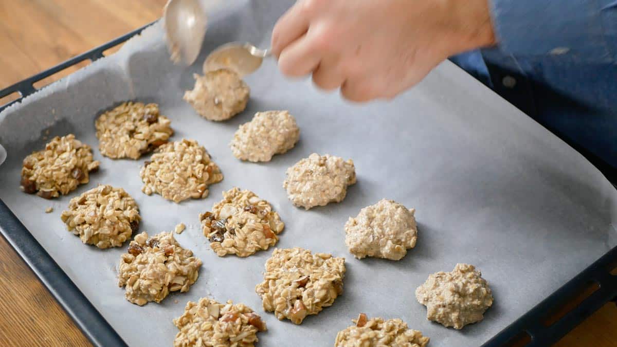 arranging the oat cookies on a baking tray