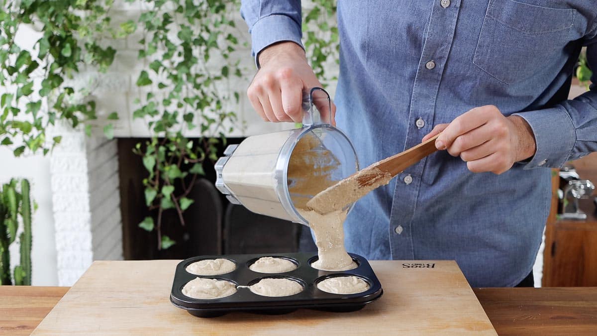 pouring the muffin batter into the pan