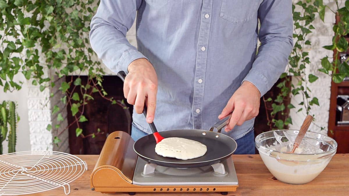 turning the vegan pancake with a spatula