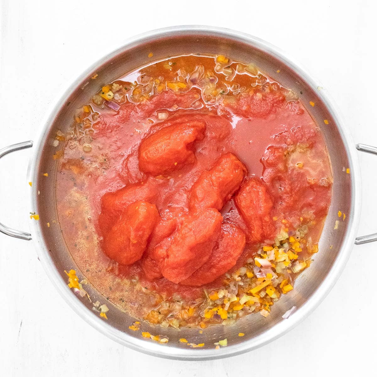 whole canned peel tomatoes in the pan