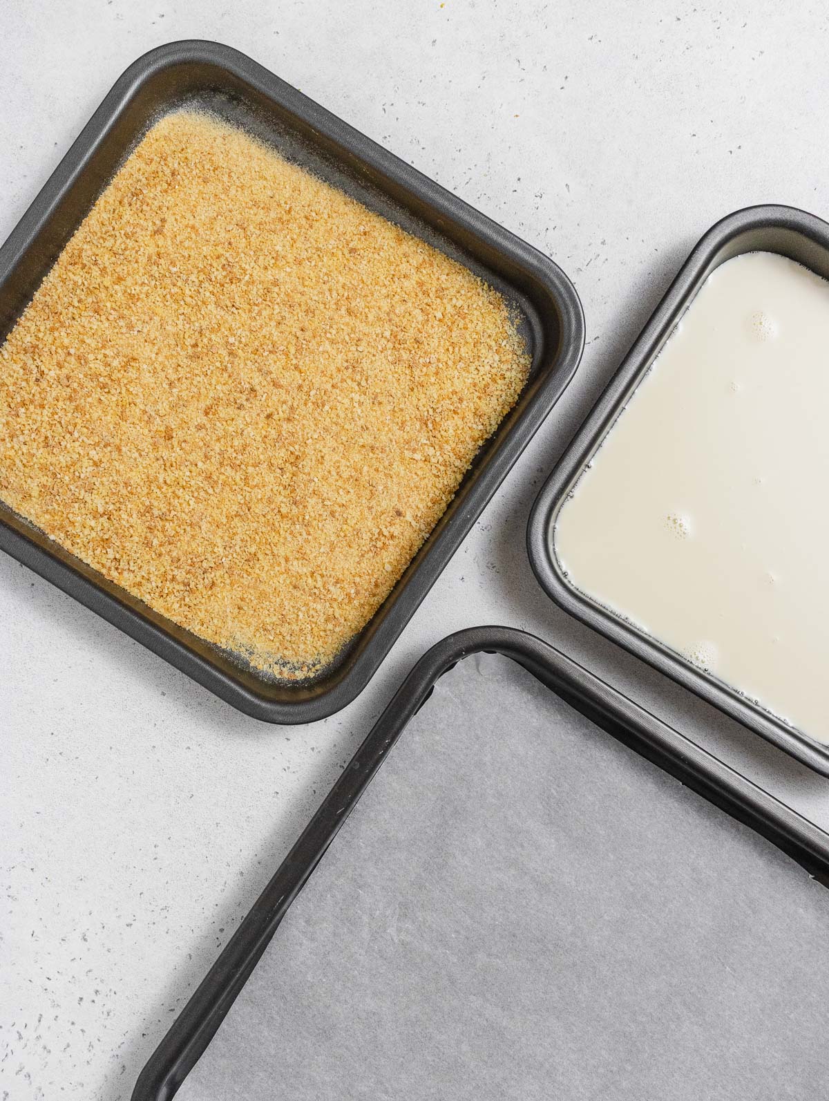baking trays with parchment paper,  breadcrumbs, and plant milk