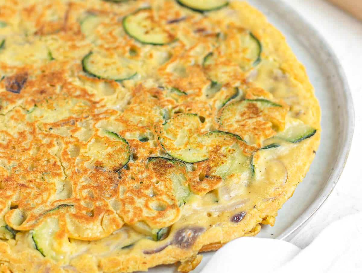 Chickpea frittata with zucchini and red onions.