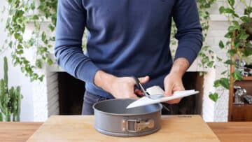 lining a cake tin with parchment paper